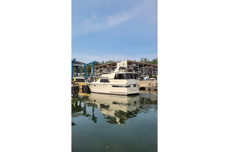 Slide: The Image of 1988 Californian 45 Motor Yacht docked at marina, reflecting on calm water. - 2