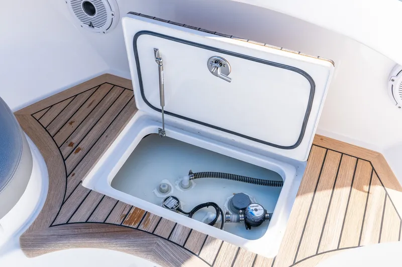 Slide: The Image of Open storage compartment on 2022 Valhalla V-46 boat with wooden deck accents. - 59
