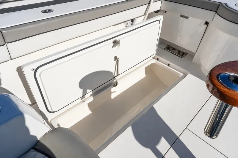 Slide: The Image of Valhalla V-46 2022 boat interior with open storage compartment and seating area. - 56