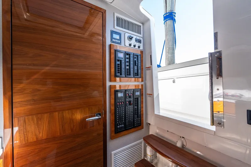 Slide: The Image of Interior view of 2022 Valhalla V-46 yacht featuring control panels and wooden door. - 39
