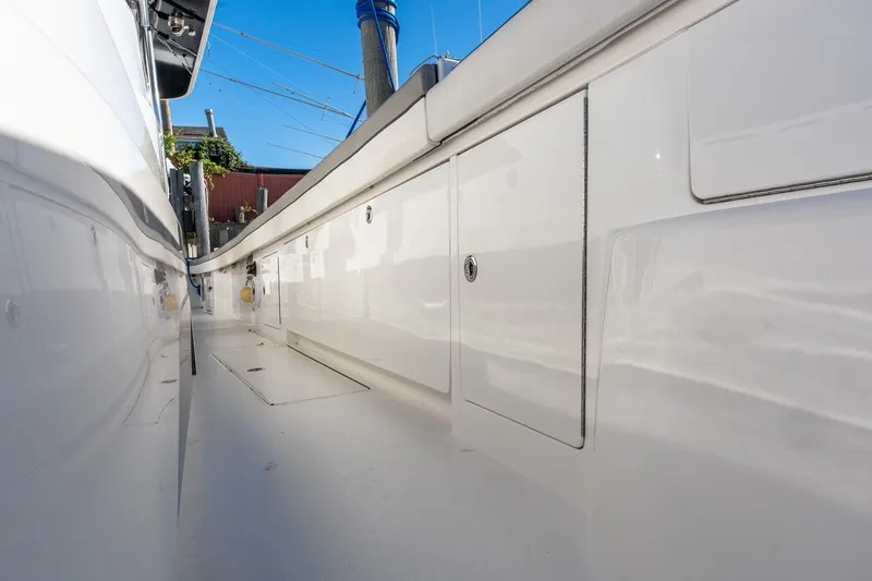 Slide: The Image of Valhalla V-46 2022 boat deck with sleek white finish and storage compartments. - 46