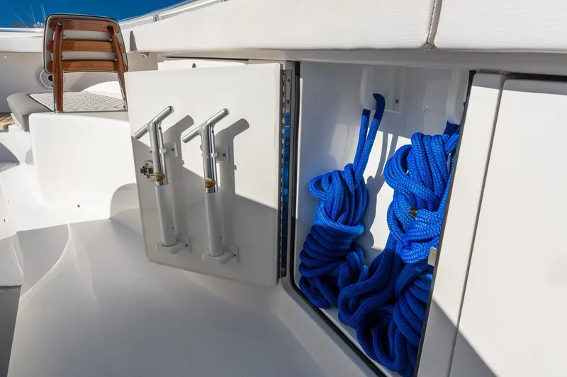 Slide: The Image of Valhalla V-46 2022 boat storage with blue ropes and rod holders. - 51