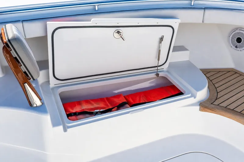 Slide: The Image of Storage compartment on 2022 Valhalla V-46 boat with red life jackets inside. - 53