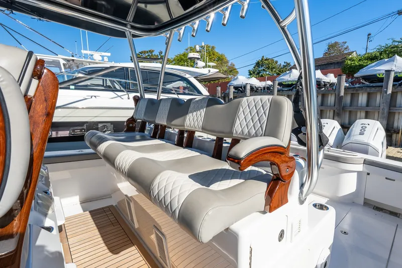 Slide: The Image of 2022 Valhalla V-46 boat interior with cushioned seating and polished wood accents. - 24