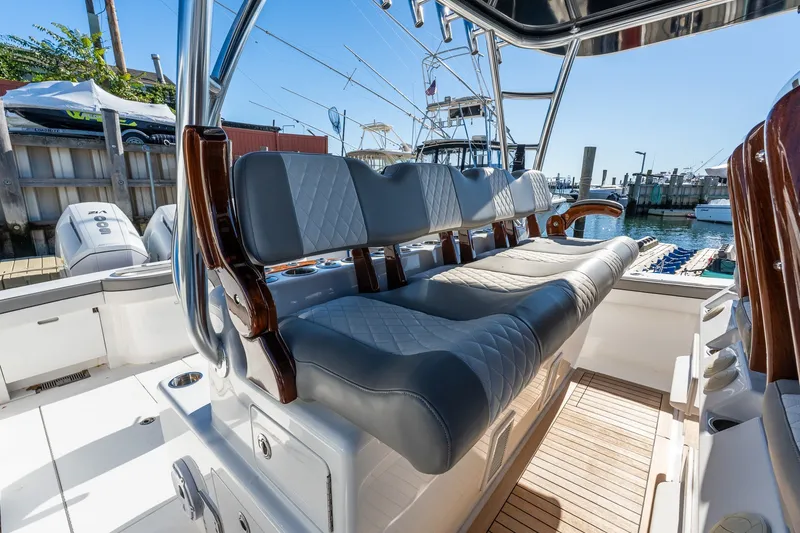 Slide: The Image of Luxurious seating on 2022 Valhalla V-46 boat, docked at marina under clear blue sky. - 21
