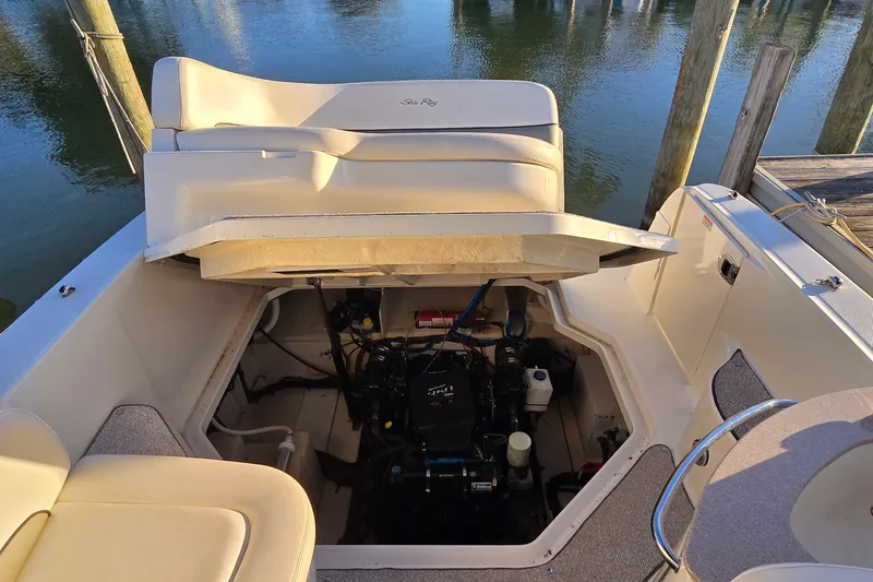 Slide: The Image of 2005 Sea Ray Sundancer 260 boat engine compartment with open hatch, dockside view. - 22