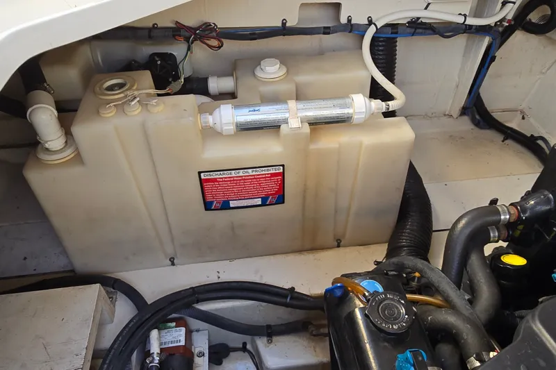 Slide: The Image of Engine compartment of a 2005 Sea Ray Sundancer 260 boat, showing fuel and oil systems. - 26