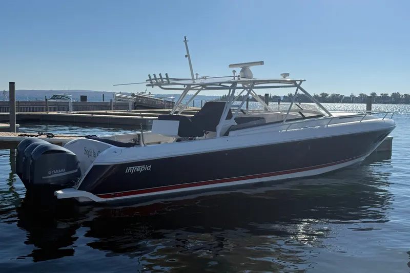 The Image of 2012 Intrepid 400 Cuddy boat docked with Yamaha engines, under clear blue sky. - 0