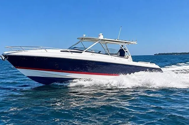 The Image of 2012 Intrepid 400 Cuddy cruising on open water under clear blue skies. - 0