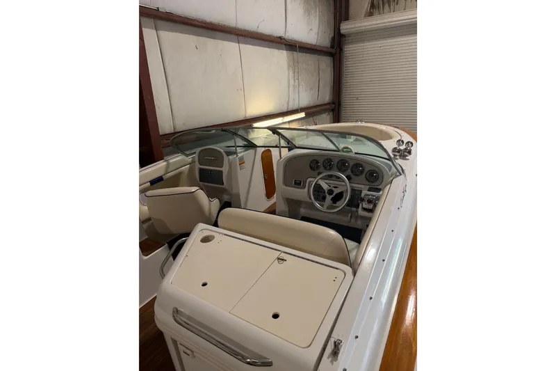 Slide: The Image of 2003 Chris-Craft Launch 28 boat interior with steering wheel and dashboard in storage. - 10