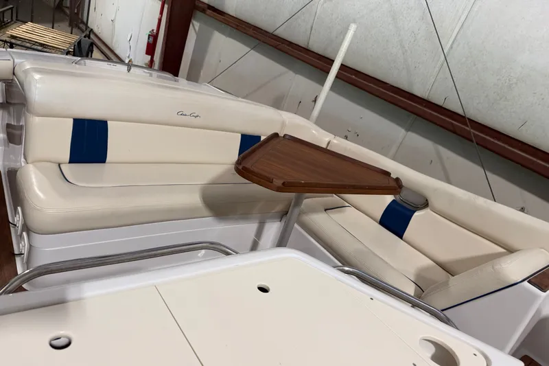 Slide: The Image of 2003 Chris-Craft Launch 28 boat interior with white seating and wooden table. - 4