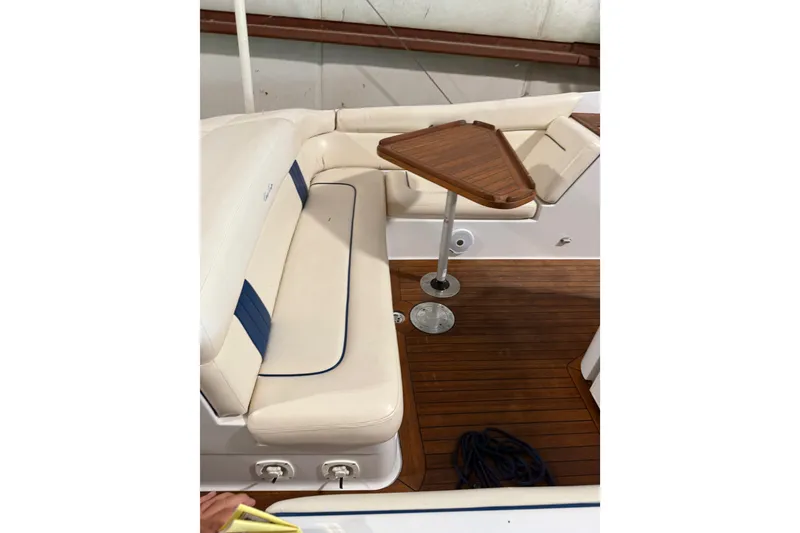 Slide: The Image of 2003 Chris-Craft Launch 28 interior with cushioned seating and wooden table. - 9
