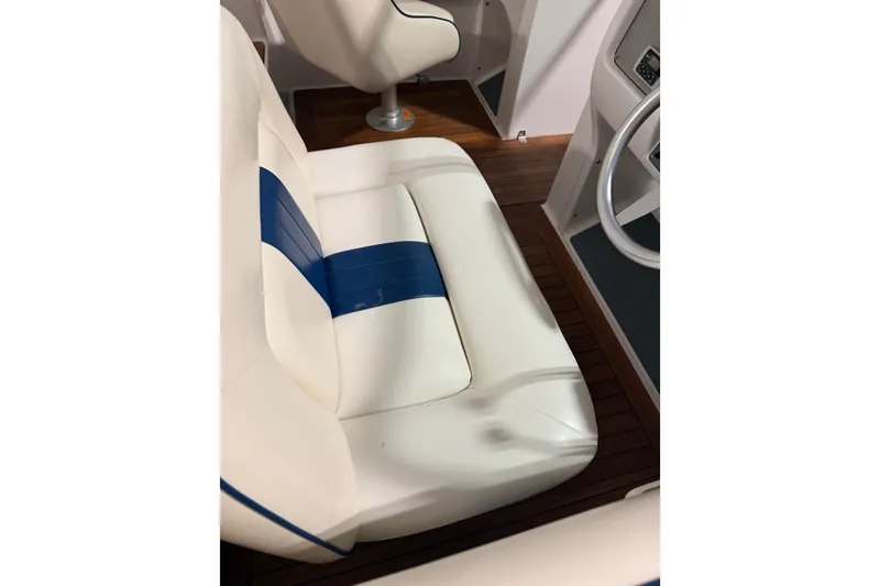 Slide: The Image of 2003 Chris-Craft Launch 28 boat interior with white and blue seating. - 5