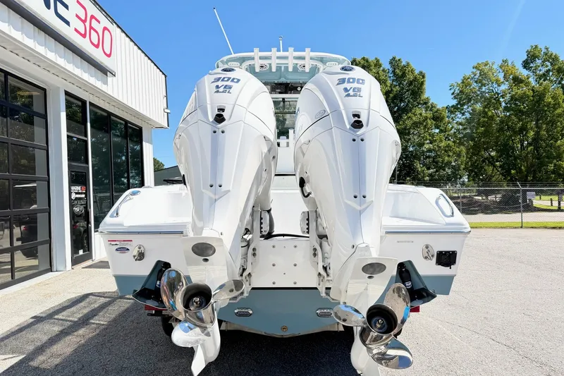 Slide: The Image of 2027 Sea Hunt BX28 boat with dual outboard engines at a dealership. - 3