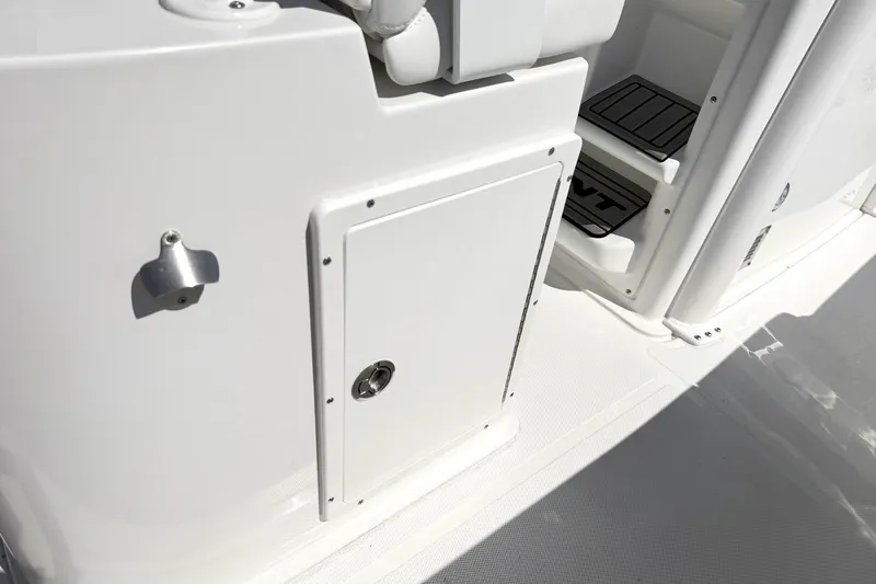 Slide: The Image of 2027 Sea Hunt BX28 boat interior with storage compartment and step detail. - 19