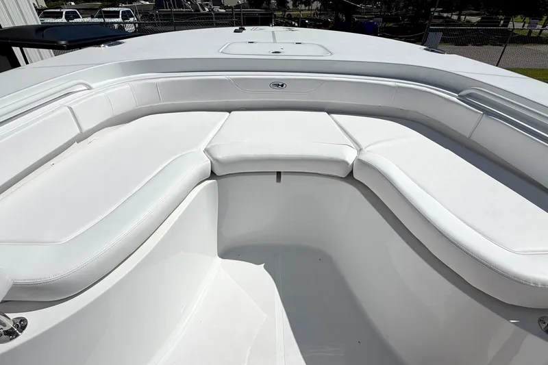 Slide: The Image of Front seating area of a 2027 Sea Hunt BX28 boat with white cushions. - 25