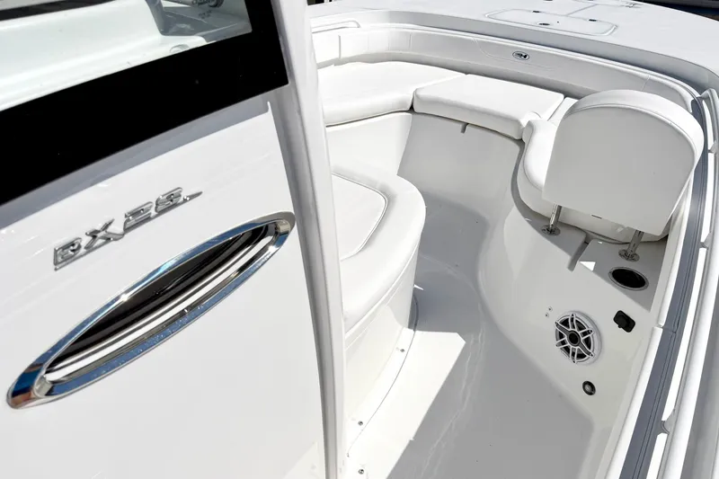Slide: The Image of 2027 Sea Hunt BX28 boat interior with white seating and sleek design. - 21