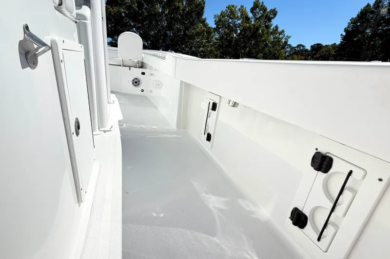 Slide: The Image of 2027 Sea Hunt BX28 boat interior with sleek white design and storage compartments. - 13