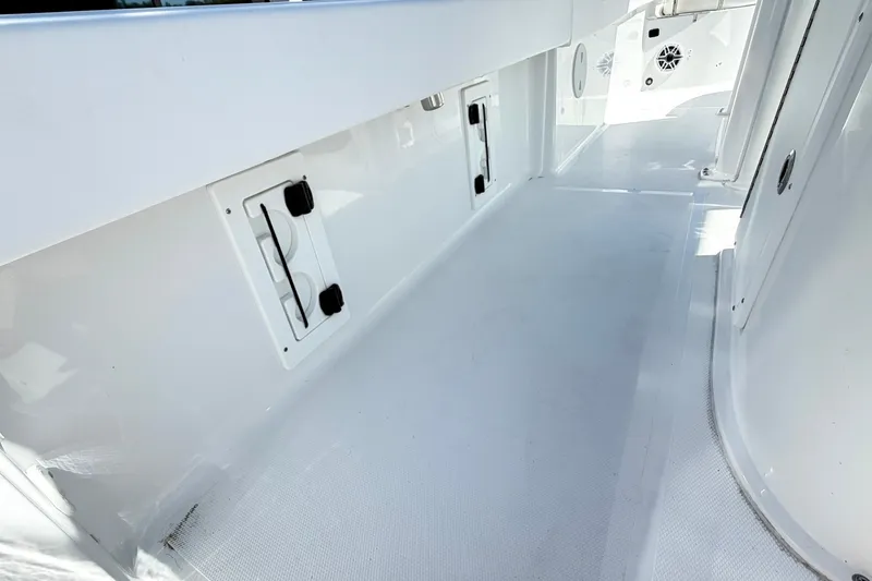 Slide: The Image of Interior view of 2027 Sea Hunt BX28 boat, showcasing sleek white deck design. - 14