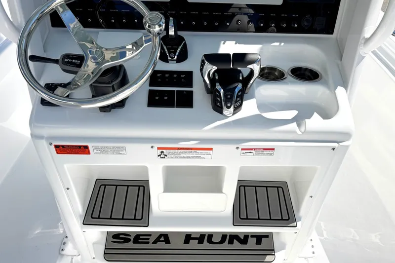 Slide: The Image of 2027 Sea Hunt BX28 boat console with steering wheel and controls. - 10