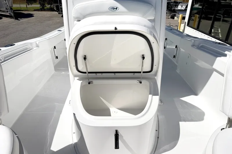 Slide: The Image of 2027 Sea Hunt BX28 boat with open storage compartment on deck. - 24