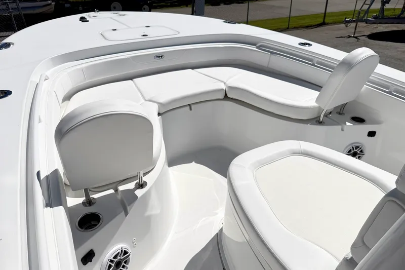 Slide: The Image of 2027 Sea Hunt BX28 boat interior with white cushioned seating and modern design. - 22