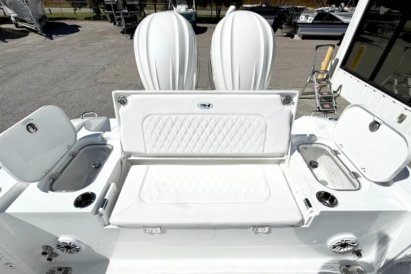 Slide: The Image of 2027 Sea Hunt BX28 boat interior with white seating and storage compartments. - 11