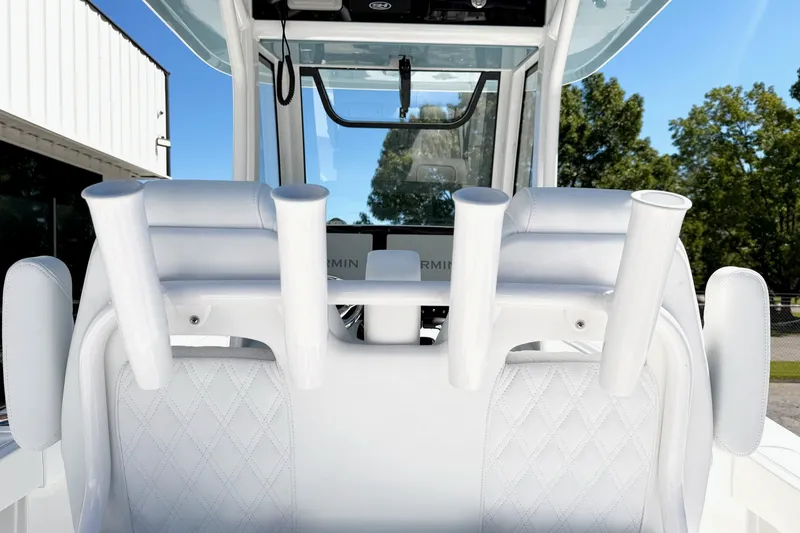 Slide: The Image of 2027 Sea Hunt BX28 boat interior with white seating and rod holders. - 6