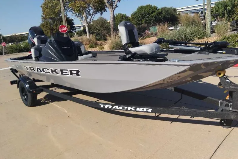 The Image of 2027 Tracker Pro 170 boat on trailer, parked outdoors, with trees and stop sign in background. - 0