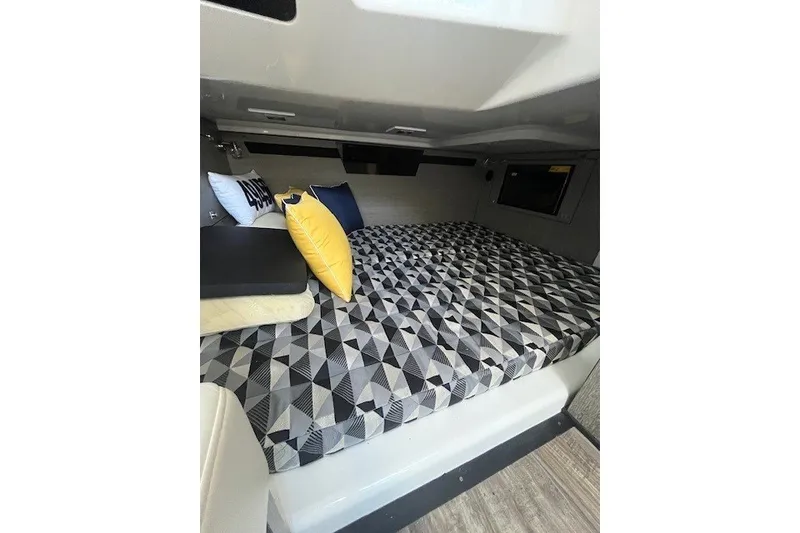 Slide: The Image of 2024 Monterey 378SS Super Sport cabin with geometric-patterned bed and decorative pillows. - 16