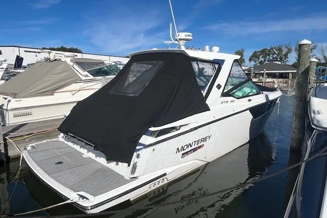 Slide: The Image of 2024 Monterey 378SS Super Sport boat docked, featuring sleek design and black canopy. - 2