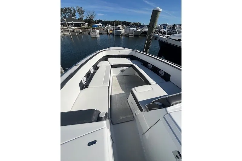 Slide: The Image of 2024 Monterey 378SS Super Sport boat interior with spacious seating at a marina. - 10