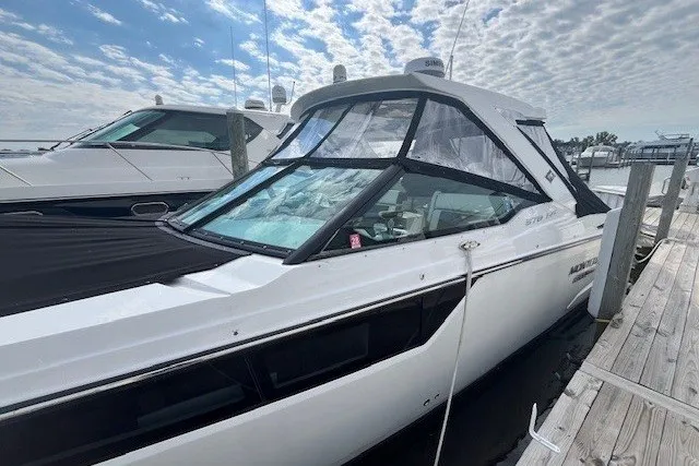 Slide: The Image of 2024 Monterey 378SS Super Sport boat docked at marina under cloudy sky. - 1
