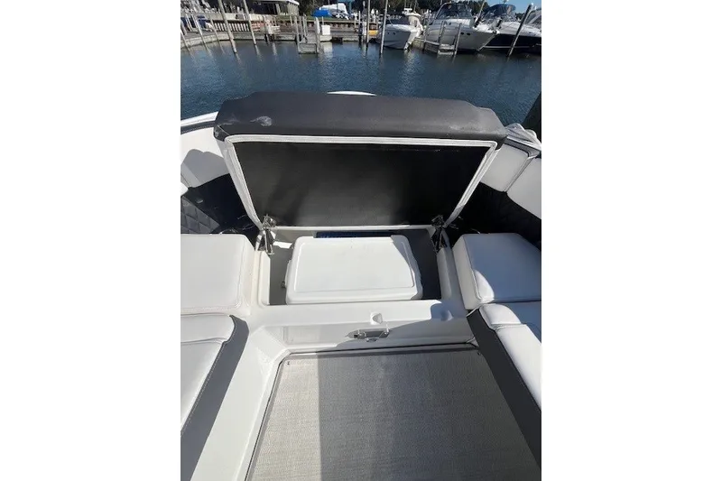 Slide: The Image of 2024 Monterey 378SS Super Sport boat with open storage compartment at marina. - 11