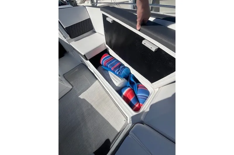 Slide: The Image of 2024 Monterey 378SS Super Sport boat storage compartment with colorful towels inside. - 12