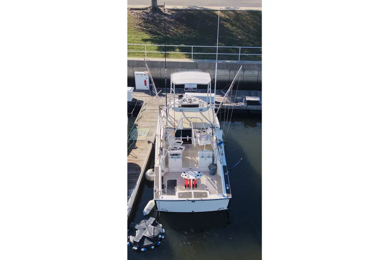 Slide: The Image of Aerial view of a 1995 Carolina Classic 28 boat docked at a marina. - 9