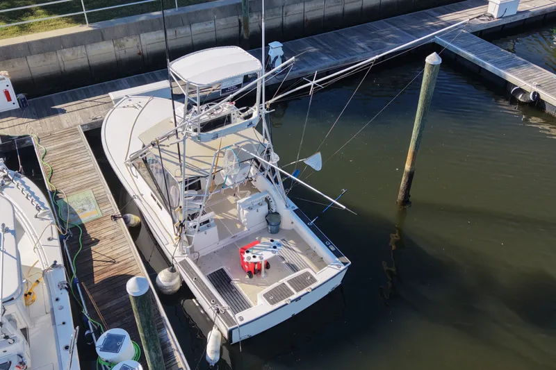 Slide: The Image of 1995 Carolina Classic 28 boat docked at marina, aerial view. - 1