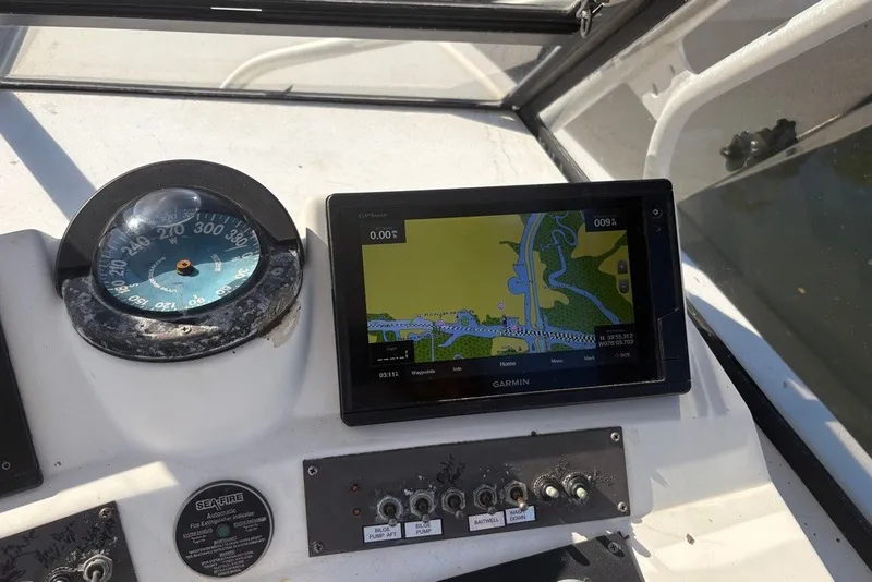 Slide: The Image of Boat dashboard with compass and Garmin GPS on a 1995 Carolina Classic 28. - 25