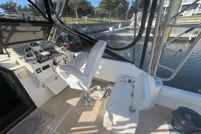 Slide: The Image of Interior view of a 1995 Carolina Classic 28 boat cockpit with steering controls. - 21