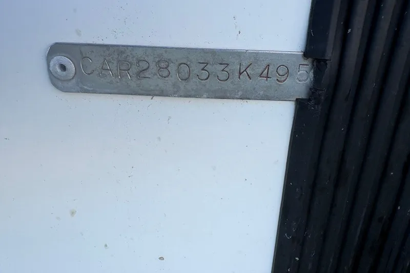 Slide: The Image of VIN plate on a 1995 Carolina Classic 28 boat, displaying serial number. - 52