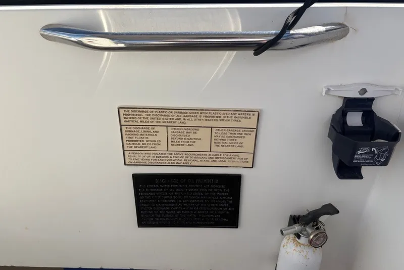Slide: The Image of 1995 Carolina Classic 28 boat with safety and waste disposal instructions on the panel. - 49