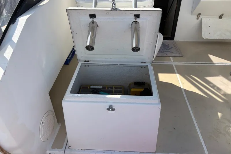 Slide: The Image of Open storage compartment on a 1995 Carolina Classic 28 boat deck. - 28