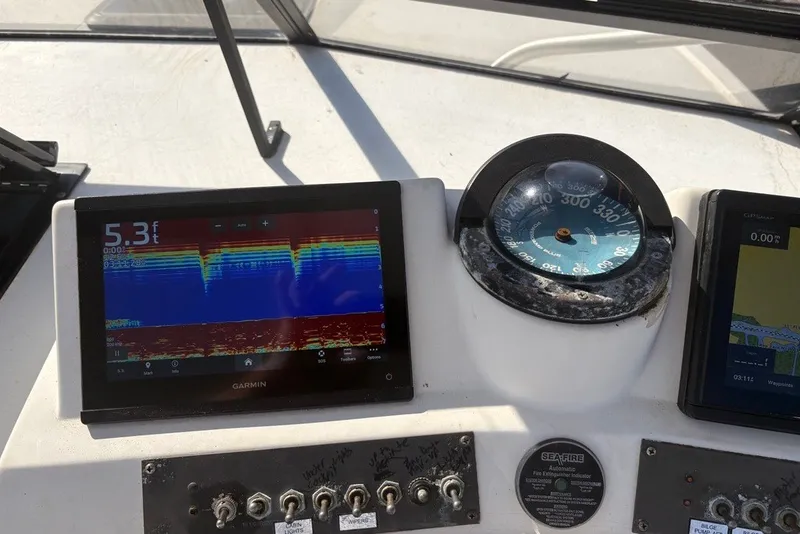 Slide: The Image of Dashboard of a 1995 Carolina Classic 28 boat with Garmin navigation equipment. - 24