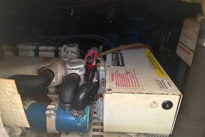 Slide: The Image of Engine compartment of a 1995 Carolina Classic 28 boat, showing mechanical components. - 48