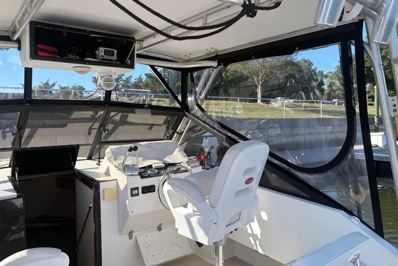 Slide: The Image of Interior view of a 1995 Carolina Classic 28 boat cockpit with steering controls. - 20