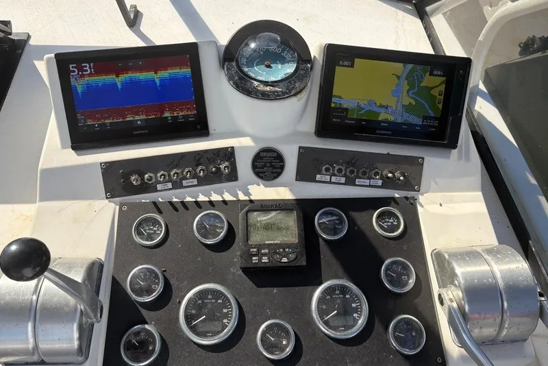 Slide: The Image of Control panel of a 1995 Carolina Classic 28 boat with navigation screens and gauges. - 23