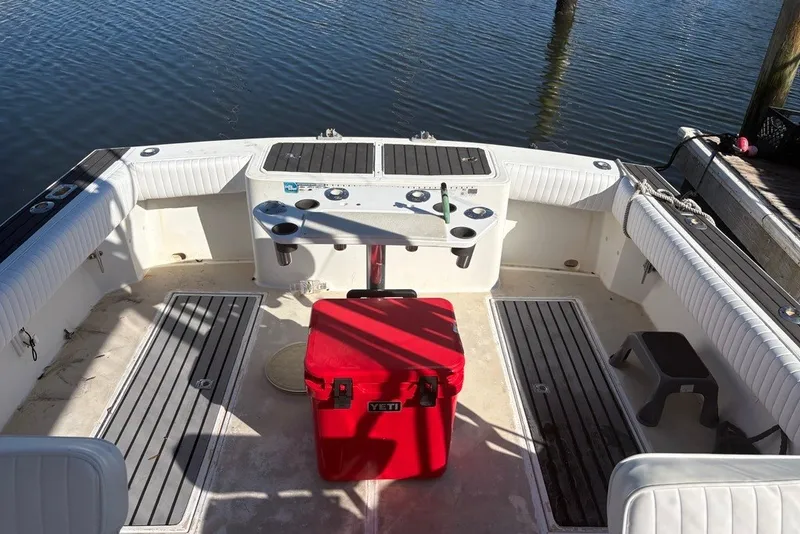Slide: The Image of 1995 Carolina Classic 28 boat interior with red cooler, docked by the water. - 29