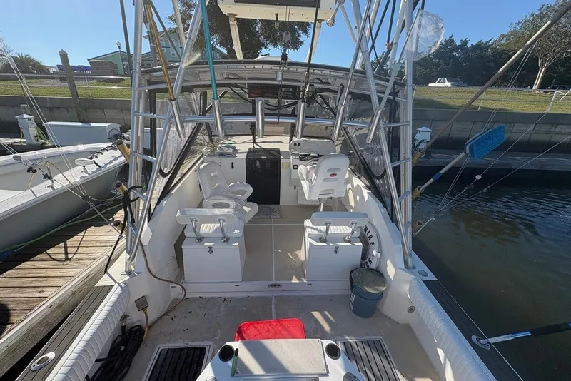 Slide: The Image of 1995 Carolina Classic 28 boat interior with fishing gear, docked at marina. - 30