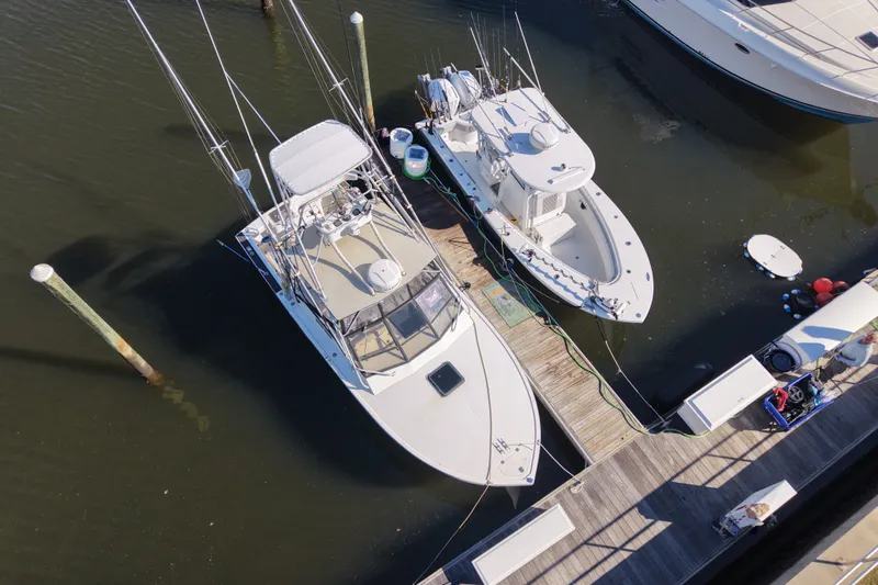 Slide: The Image of Aerial view of a 1995 Carolina Classic 28 boat docked alongside another vessel. - 10