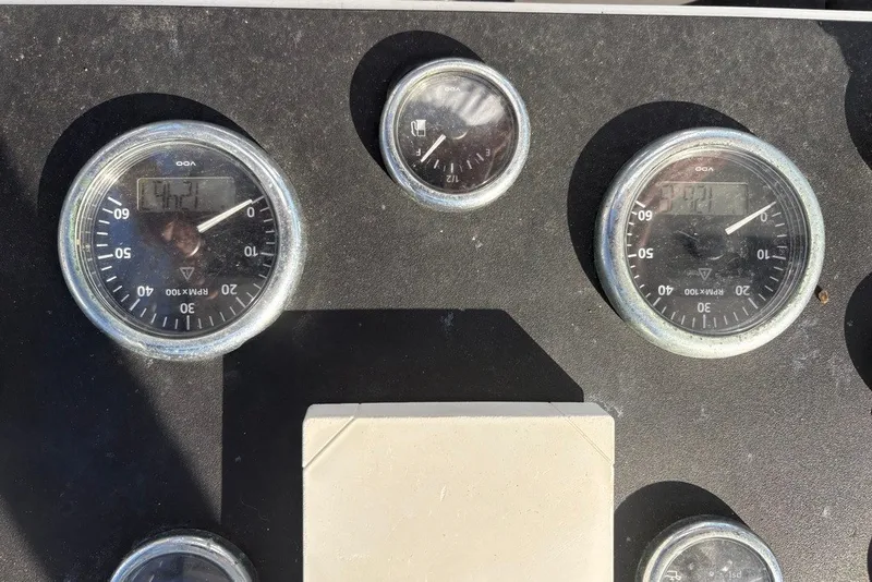 Slide: The Image of Dashboard gauges of a 1995 Carolina Classic 28 boat, displaying RPM and other metrics. - 26